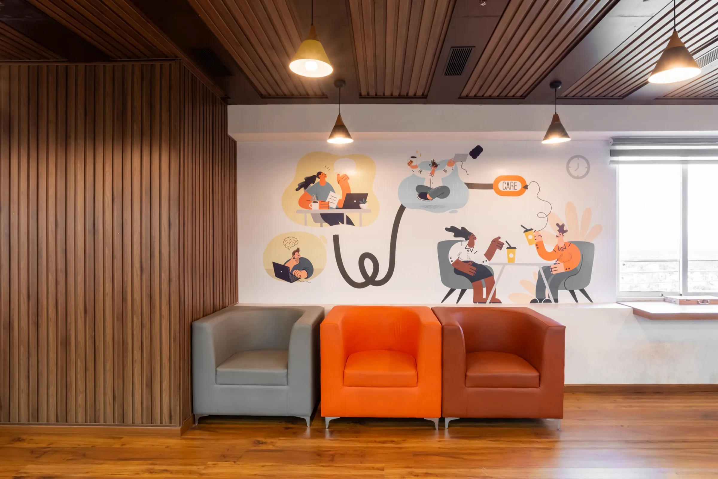 Lounge with a timber-slat ceiling, orange armchairs and an illustrated mural