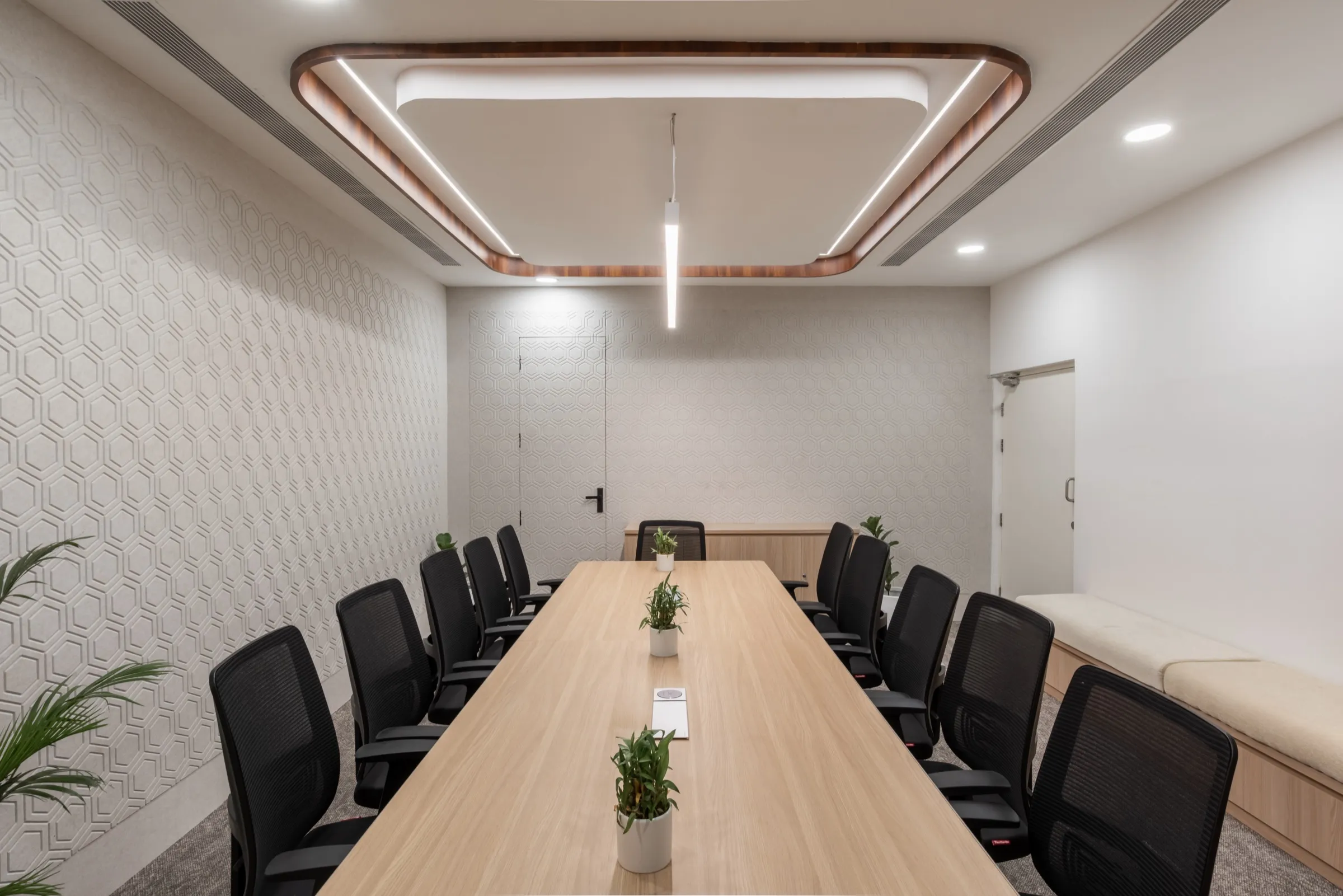 Meeting room with a long table and a lit cove ceiling